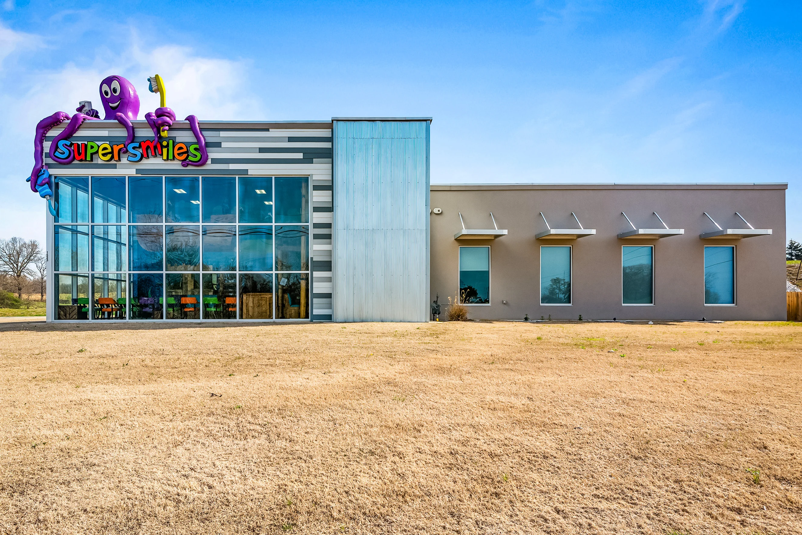 Super Smiles building exterior with the giant purple octopus logo, Harrison AR